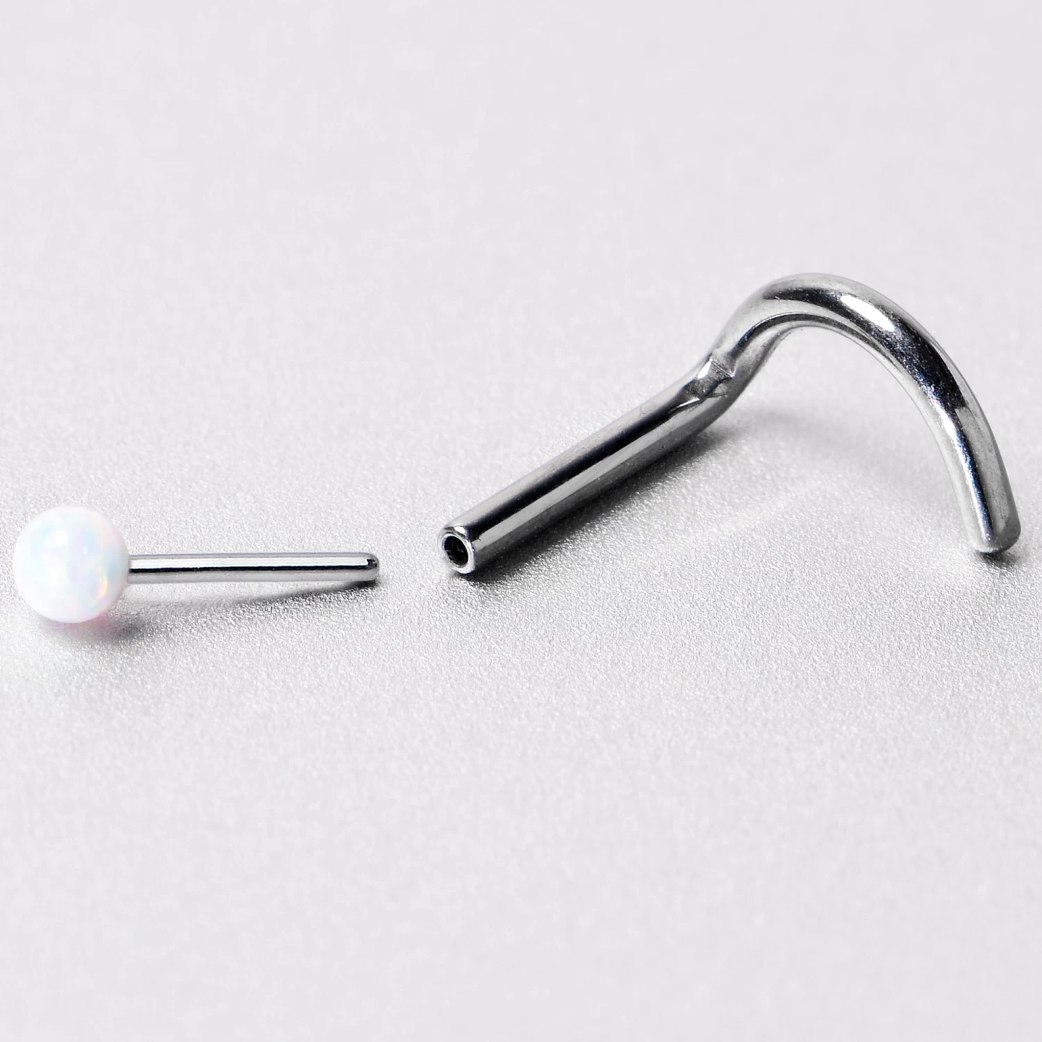 18 Gauge 1/4 White Synth Opal G23 Titanium Threadless Left Nose Screw 8 18 Gauge 1/4 White Synth Opal G23 Titanium Threadless Left Nose Screw - Image 8